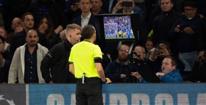 On field referee using the help of Video Assistant Referee (VAR) which could be replaced with Football Video Support (FVS)