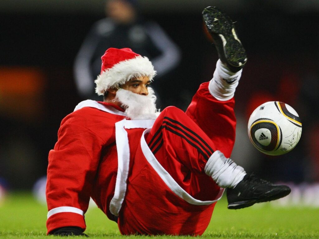 Santa Claus playing football
